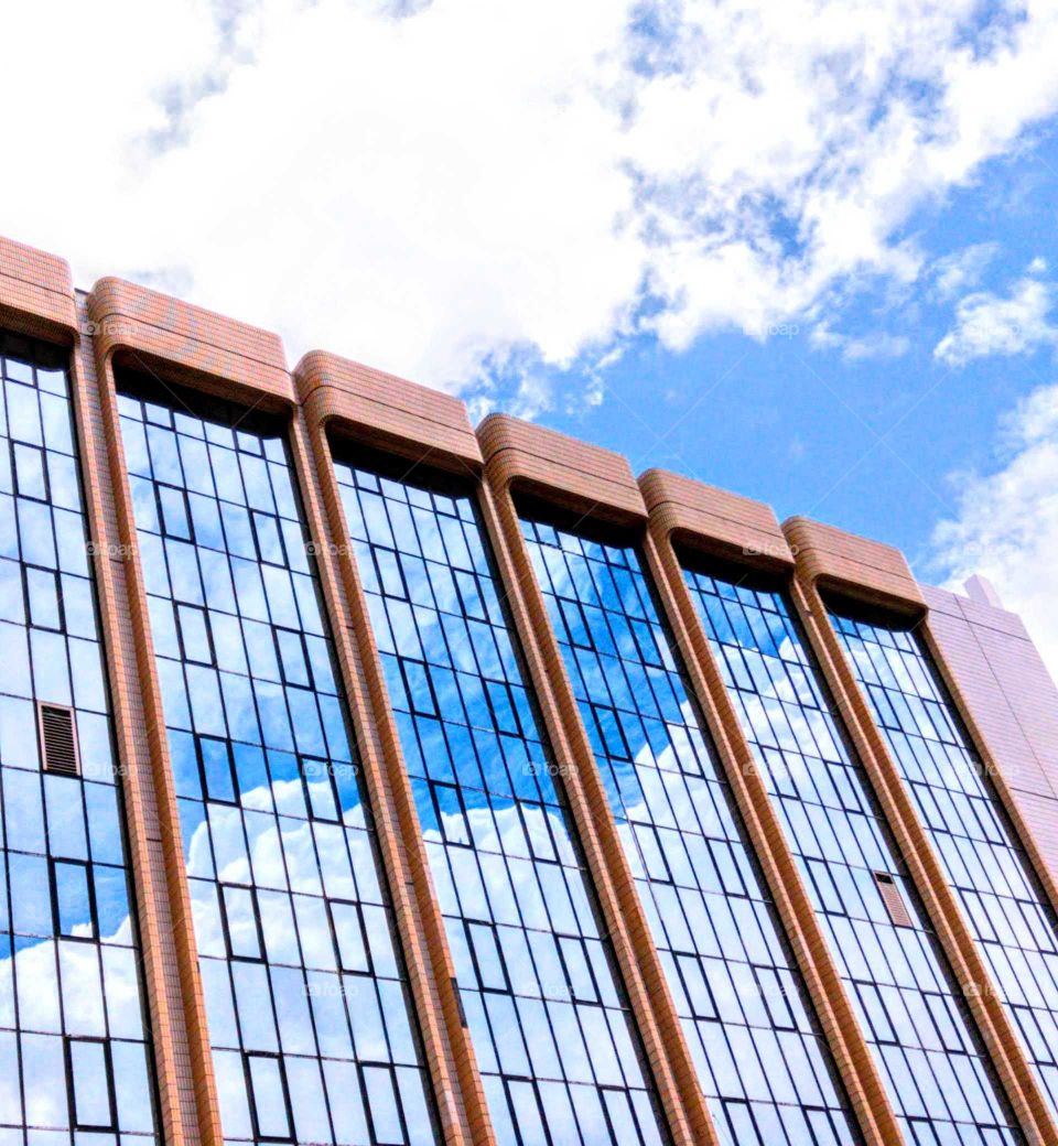 Shapes: Rectangle. the building windows inside and outside all blue sky and white clouds view.