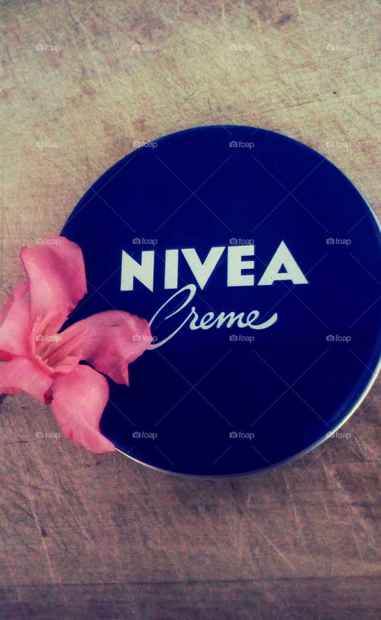 Box of Nivea cream and pink beautiful
spring flower