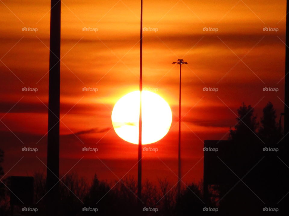 watching the sunrise over the Sacramento international airport as it turns the sky yellow red and orange