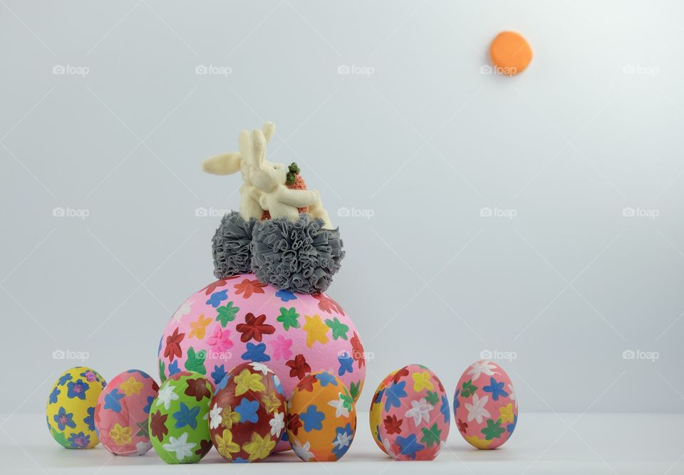 Lovers rabbits are sitting on the big easter egg to see the moon