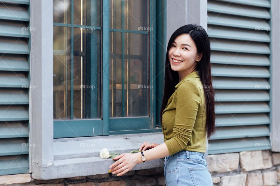 Beautiful asian woman near window 