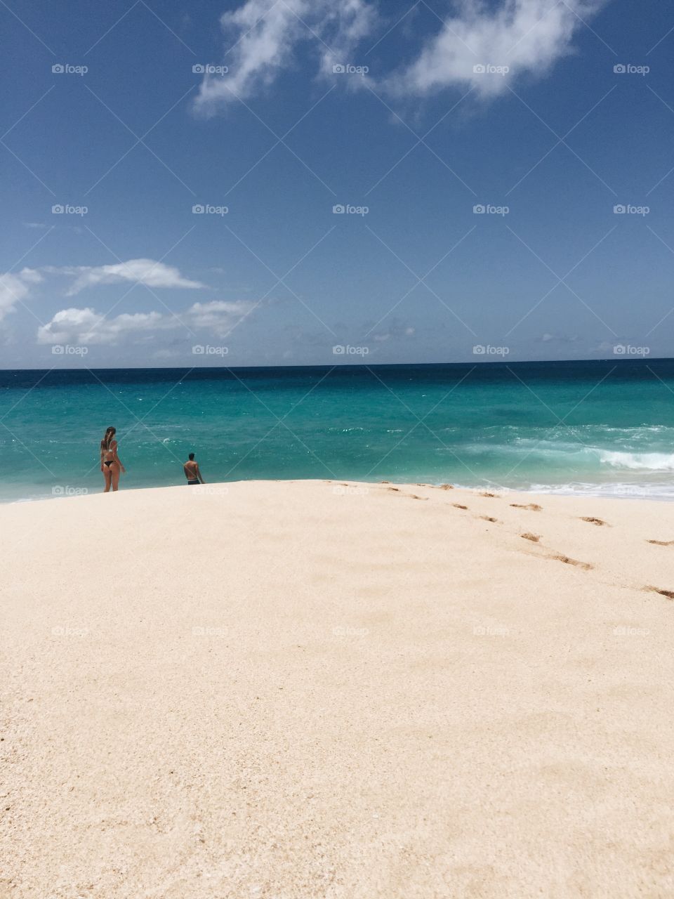 White sandy beach and blue water.