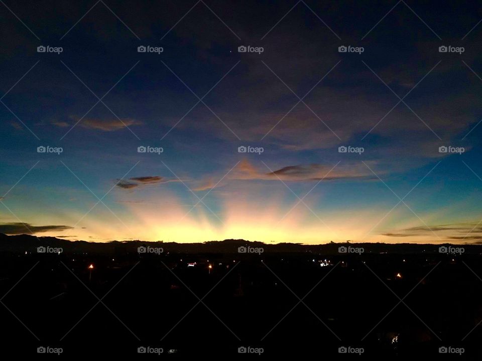 Crepuscular rays behind the mountain