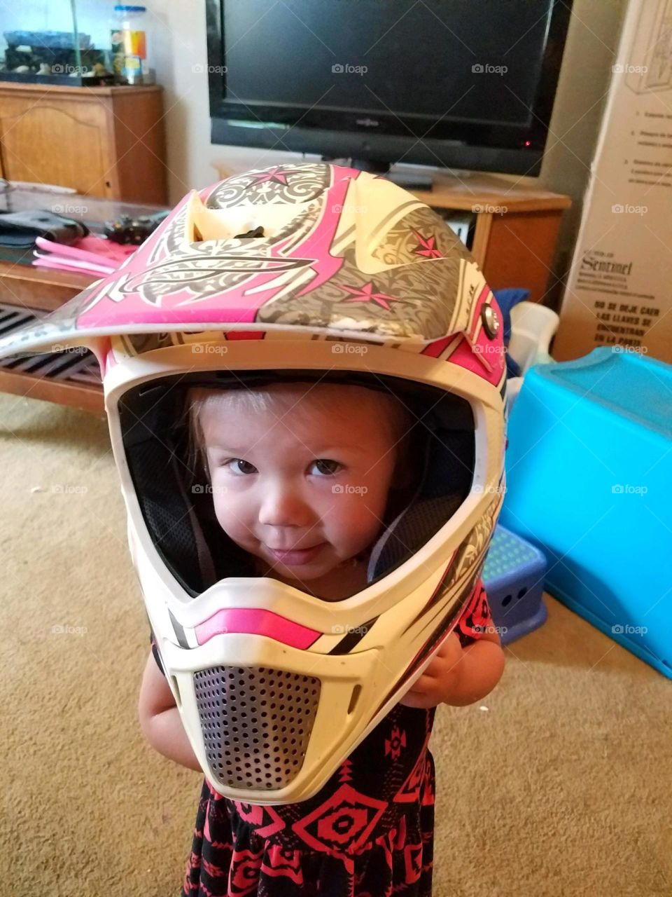 my daughter a little girl wearing a helmet that's way too big but it's super cute in Ely Nevada United States of America 2017