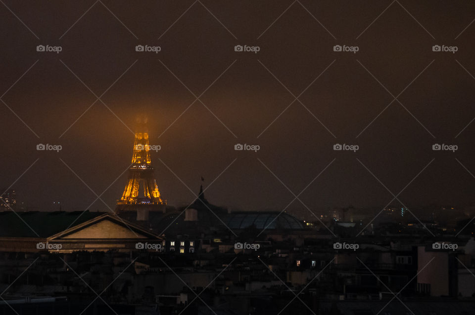 Eiffel Tower from a distance during a mist fog 
