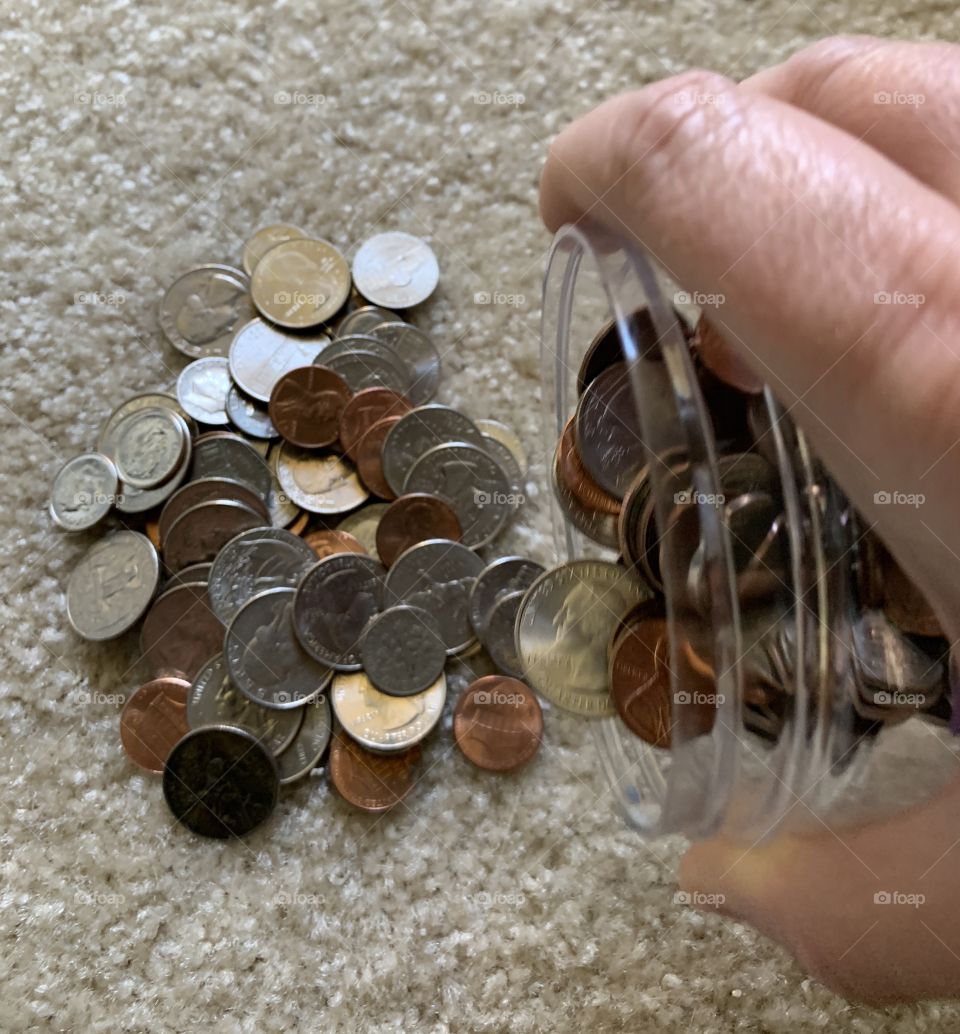 Pouring out you change jar to count your coins