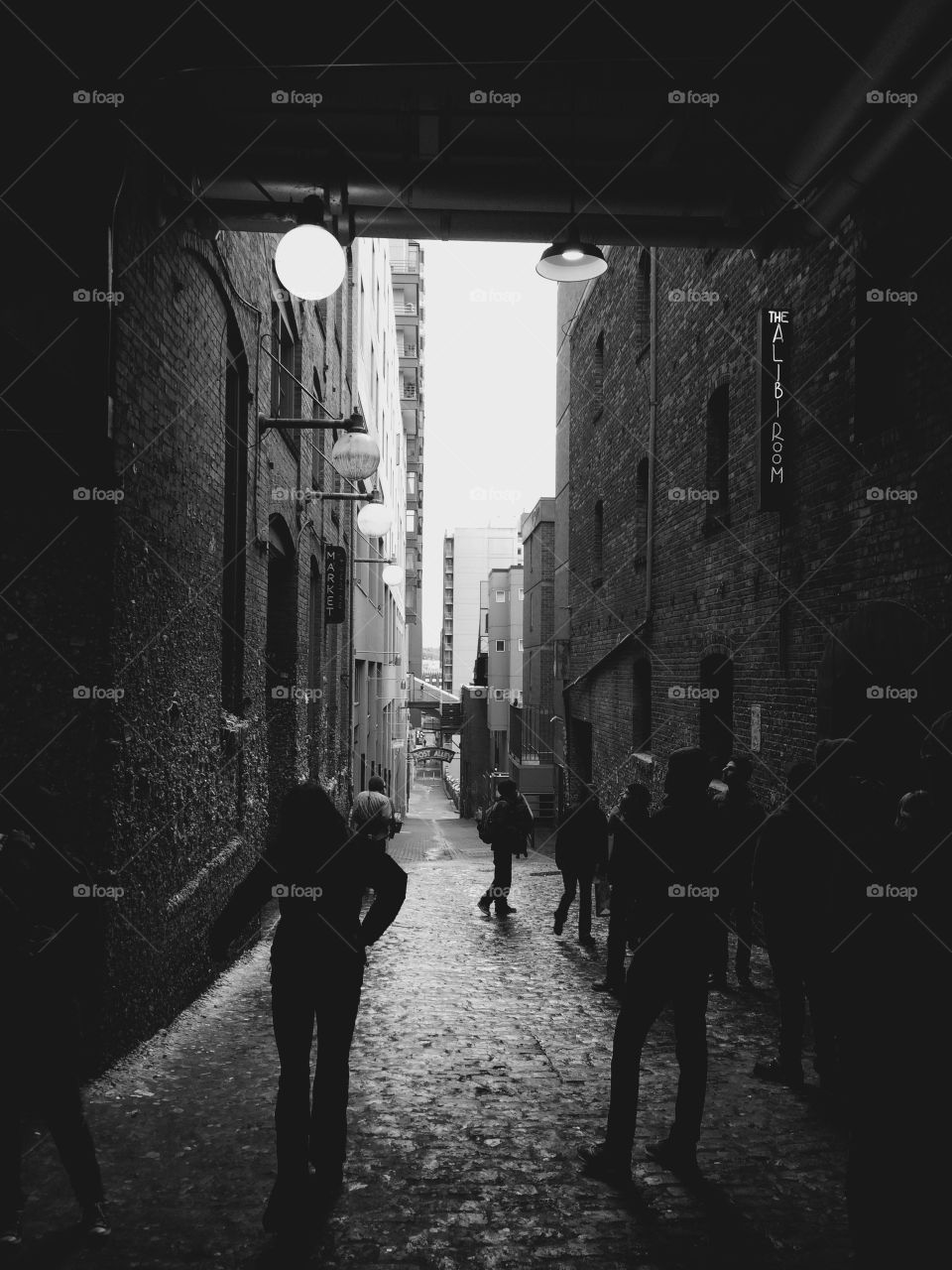 Be where you want to be. Black and white photo looking in on the gum wall street in Seattle, Washington