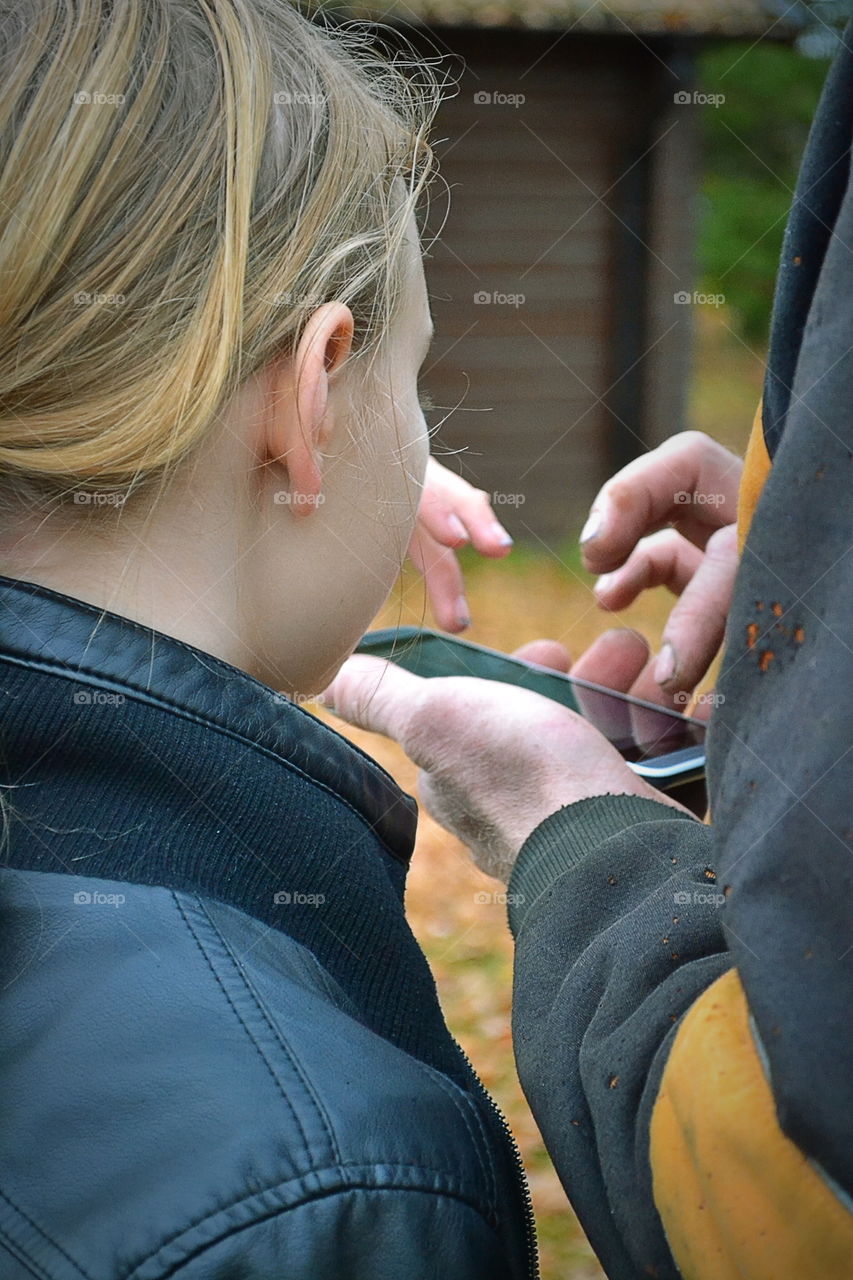 Two people with a phone