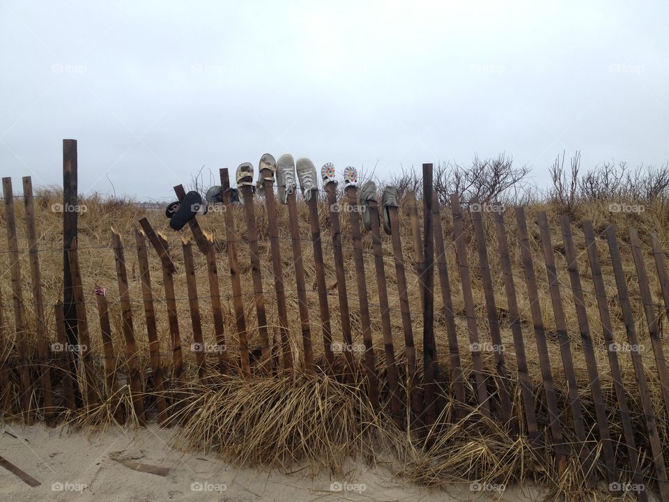 Shoes on a fence at montauk beach 