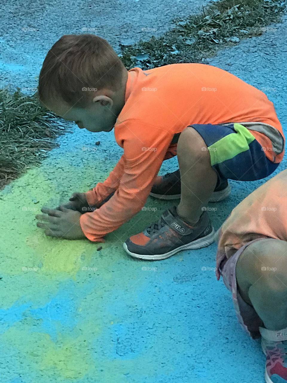 Playing in the colorful chalk dust. 