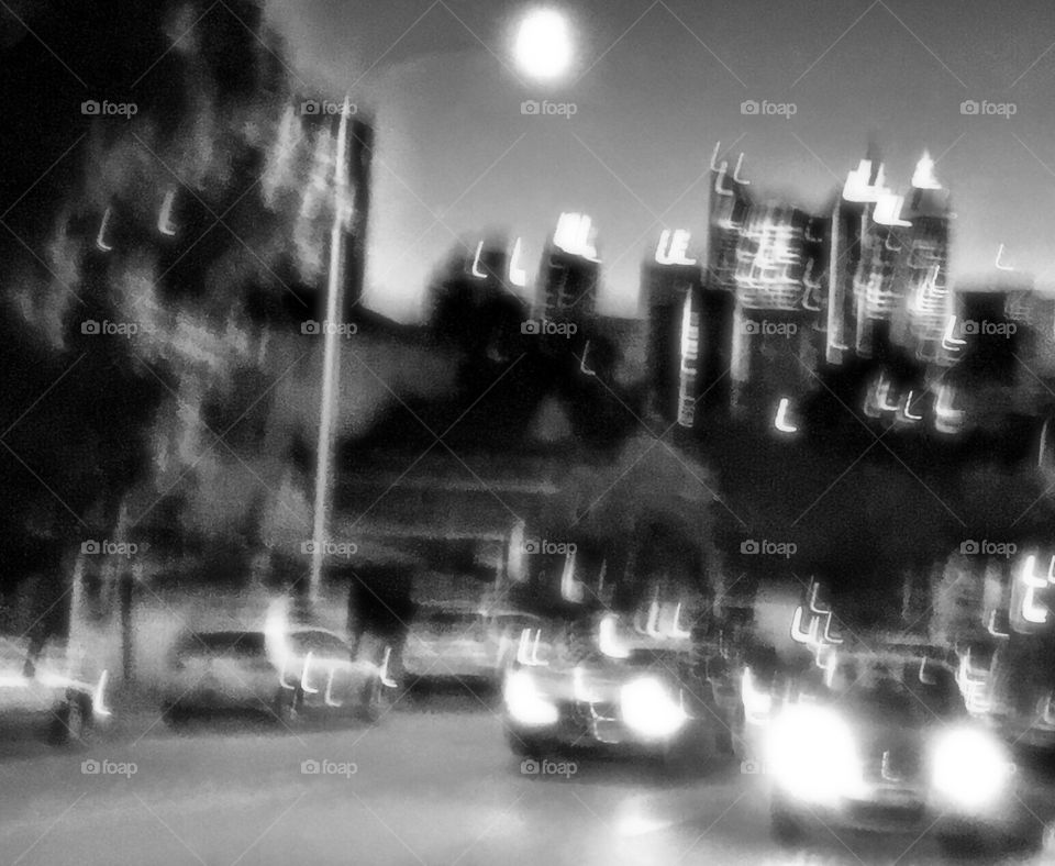 Night street view with sky scrapers. Monochrome image.