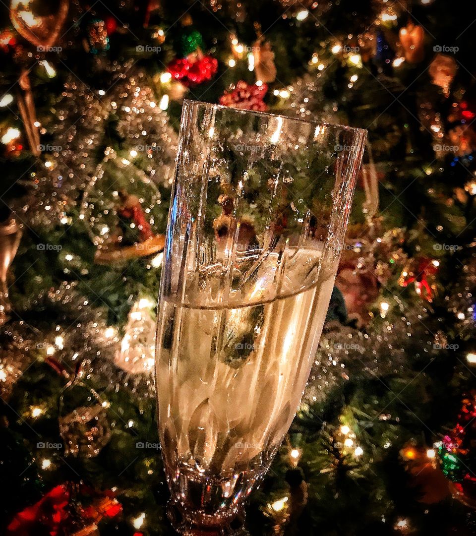 Glass of champagne in front of a Christmas tree—taken in Dyer, Indiana 