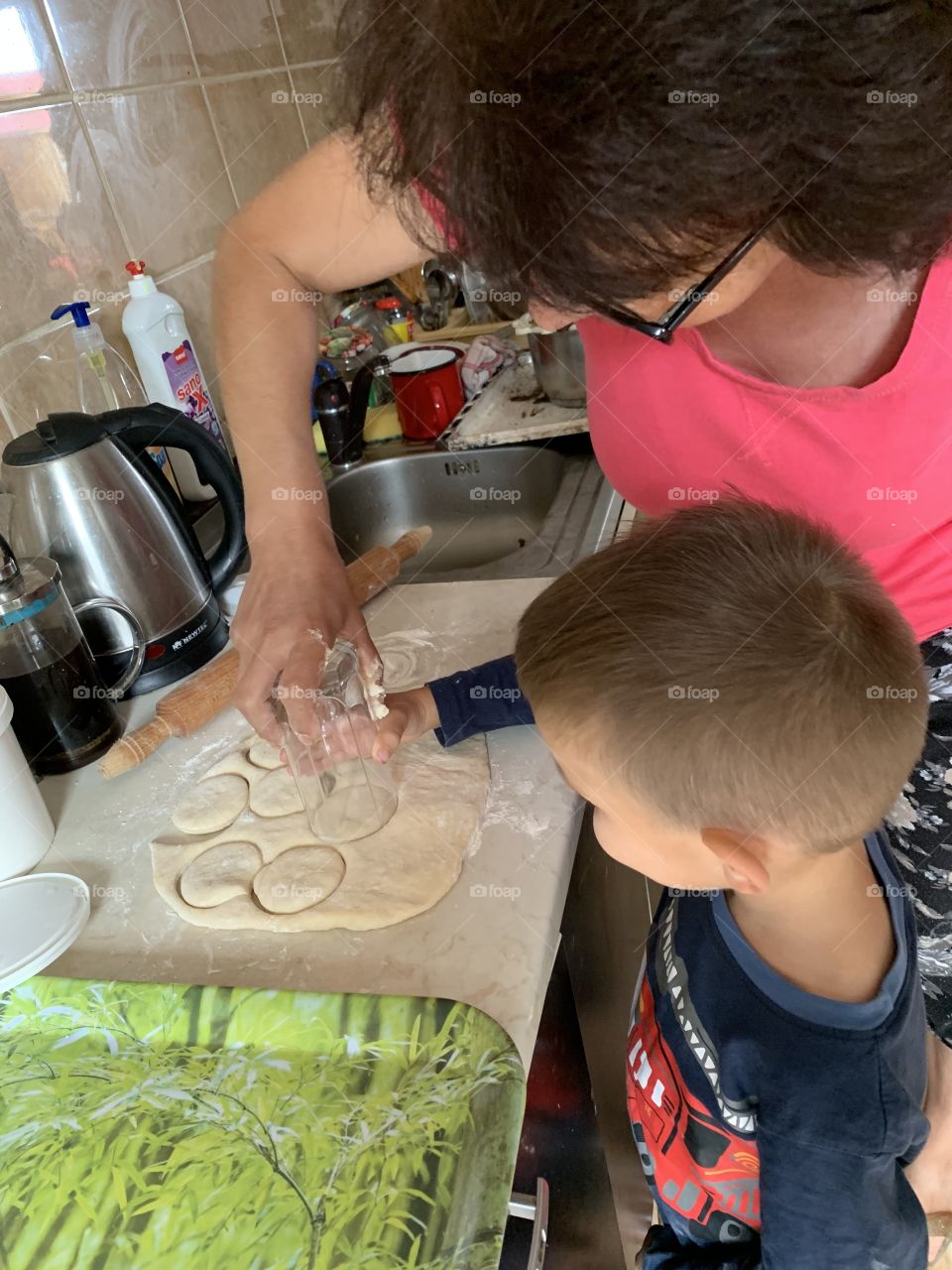Child and auntie baking cookies together 