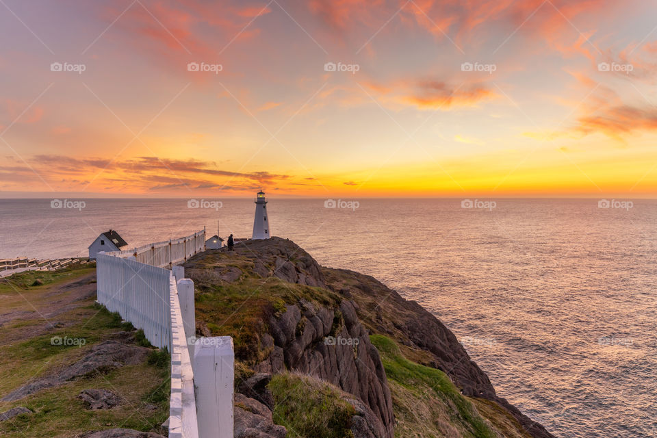 Vibrant colors light up the sky just before sunrise over Cape Spear location in Newfoundland Canada, the easternmost point in North America. 