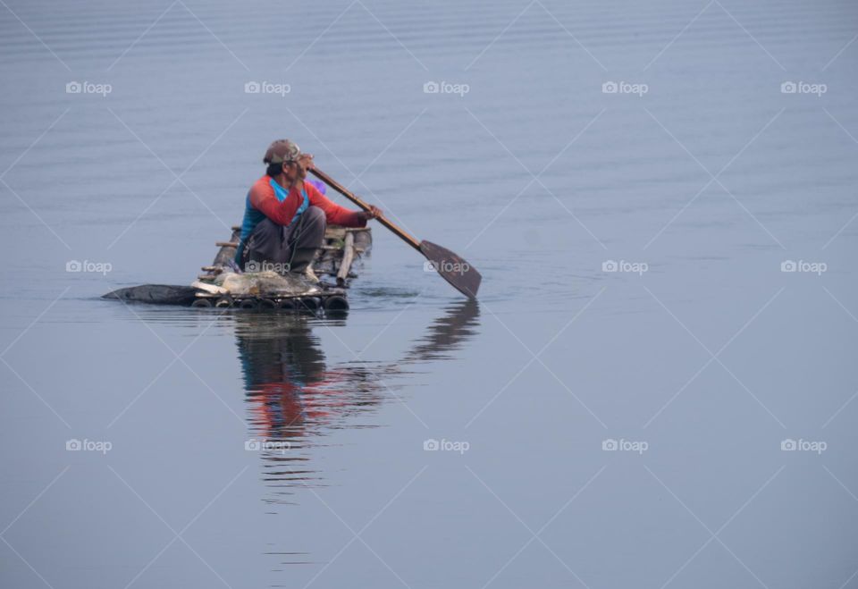 fishermen rowing bamboo canoes