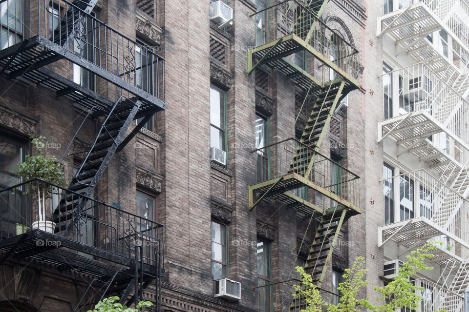 Tri-color New York City Apartments With The Typical Fire Escapes