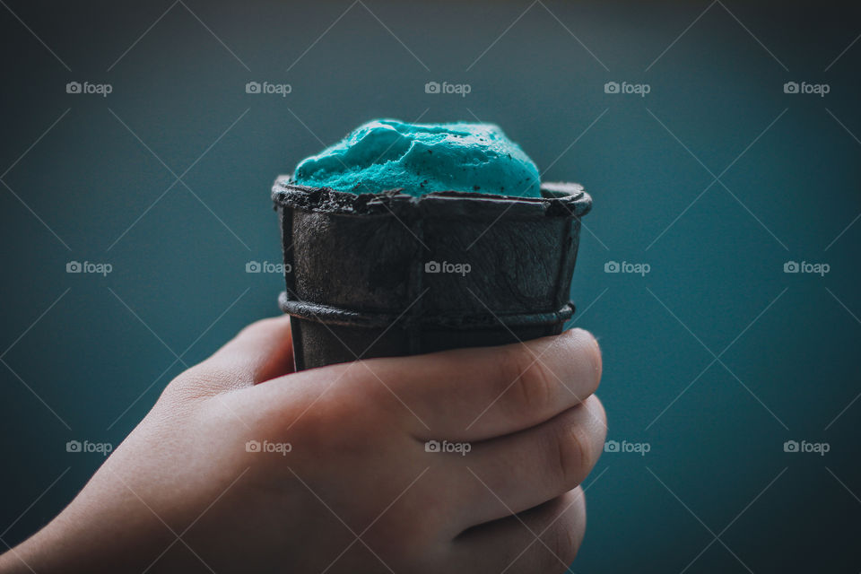 black and blue ice cream in the hands
