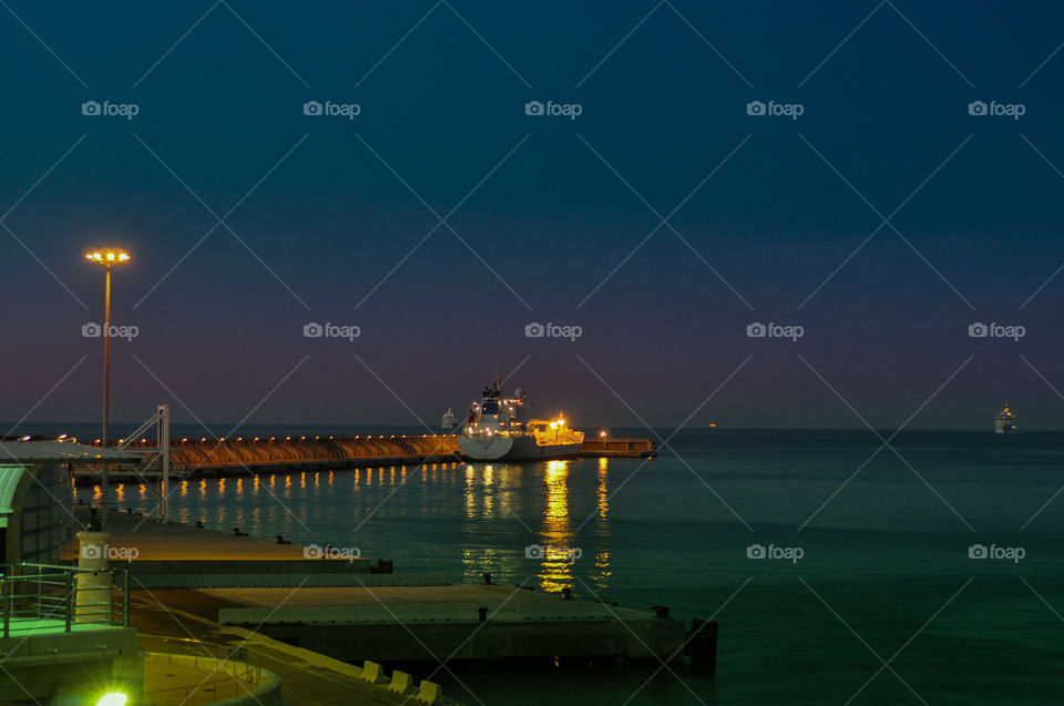 Reflection on the water in the morning in malaga's port 