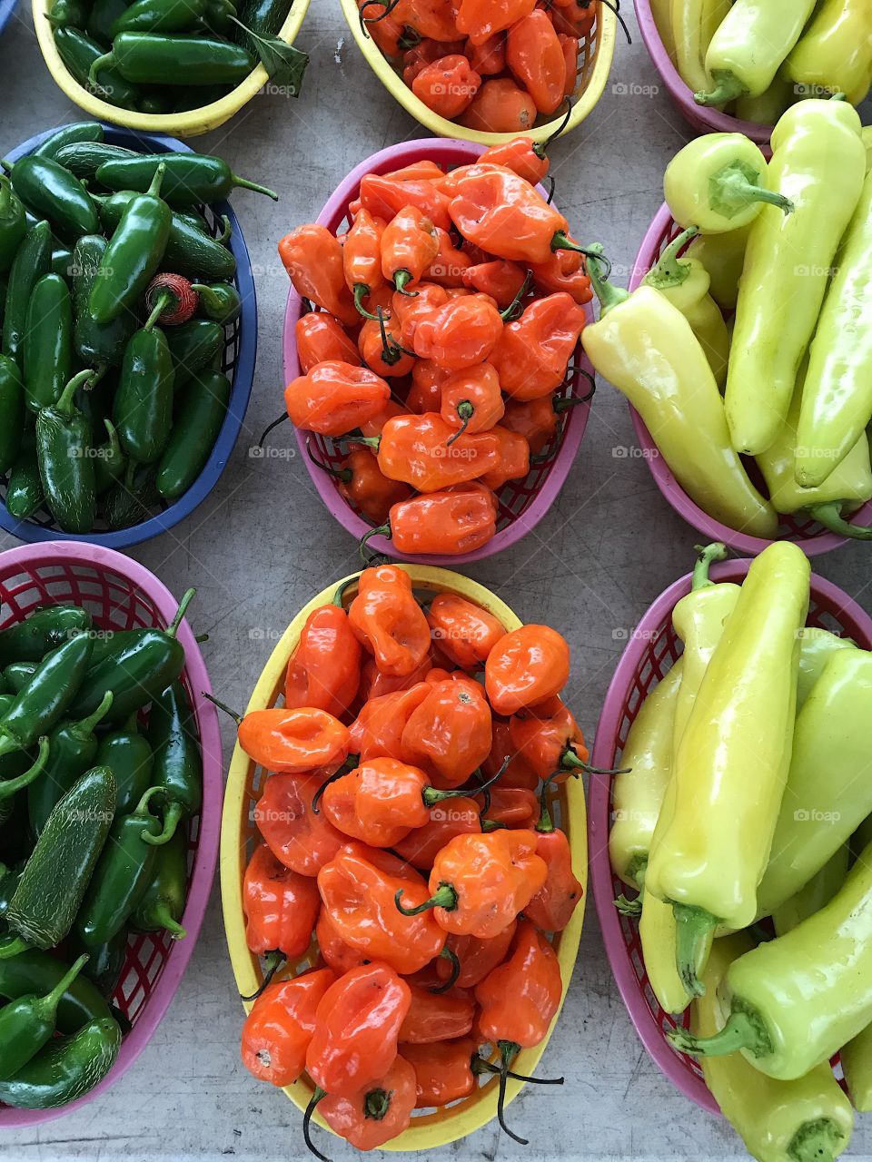 Green, orange, and yellow peppers. 