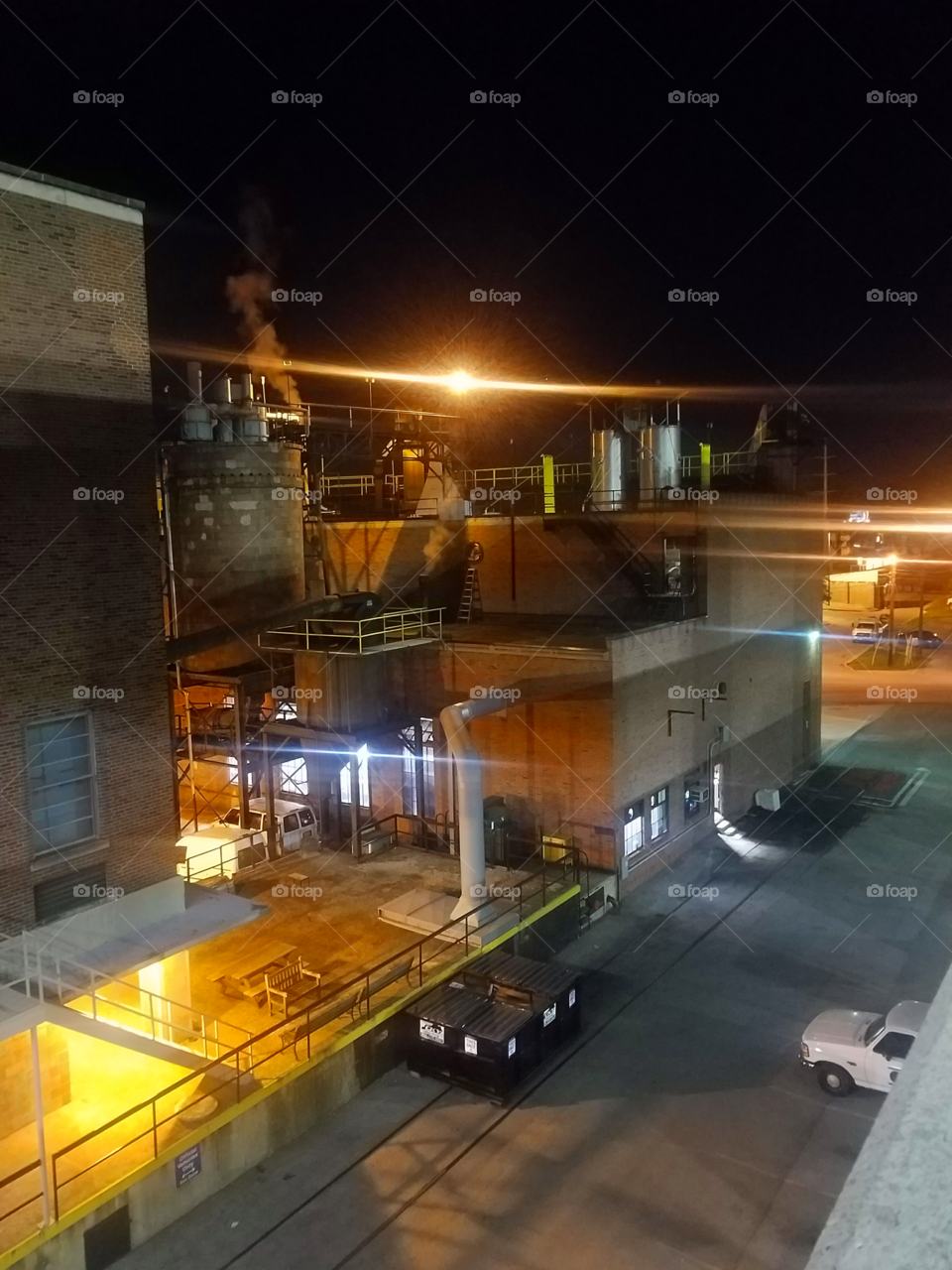 Industrial building lit up with color at night