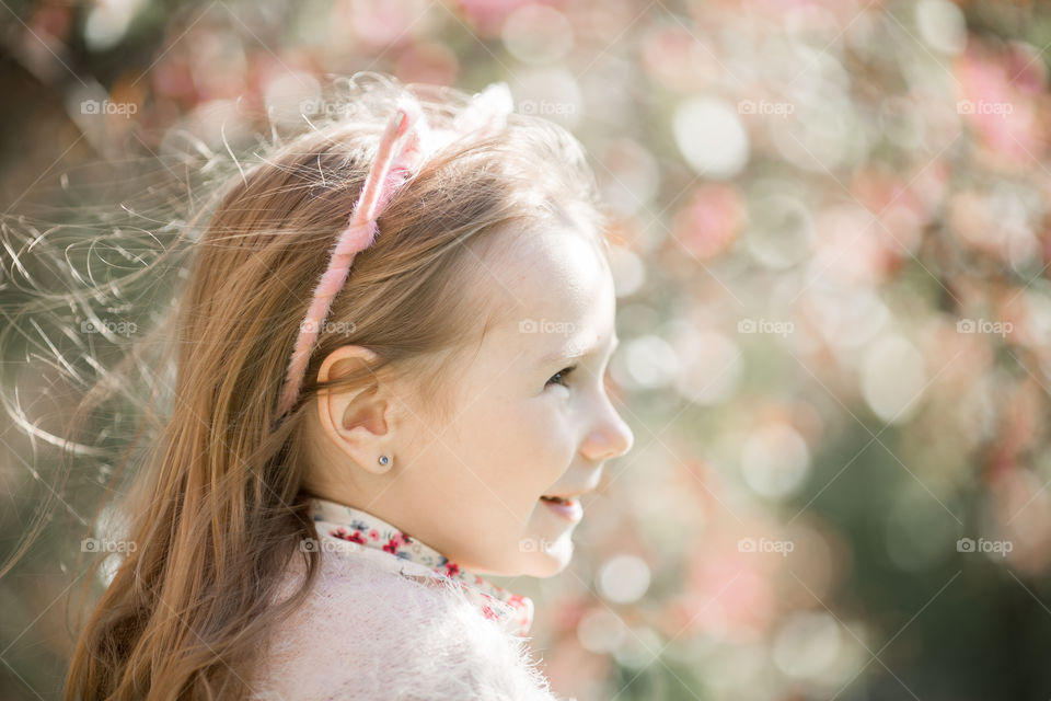 Cute Little girl in a blossom park