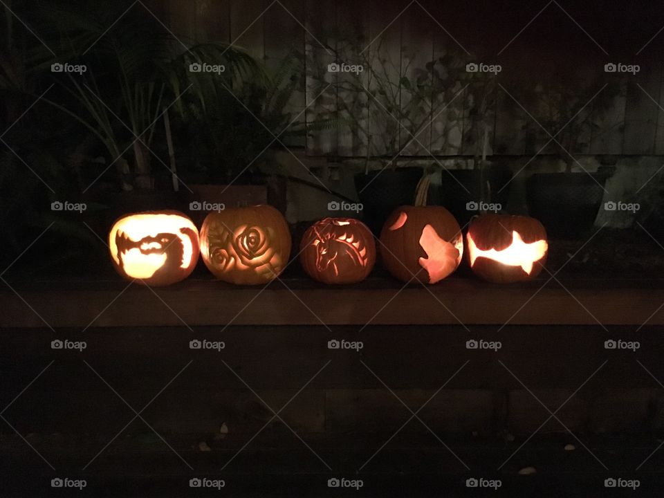 Five candle lit carved pumpkins 