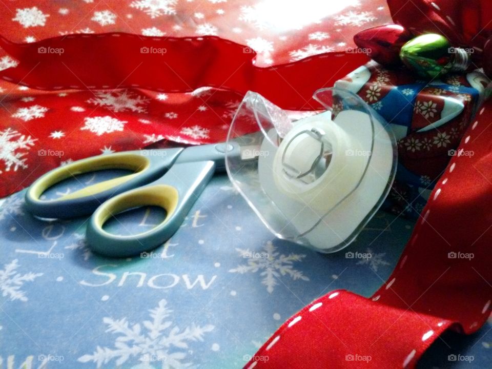 Close-up scissor and cello tape with christmas gift