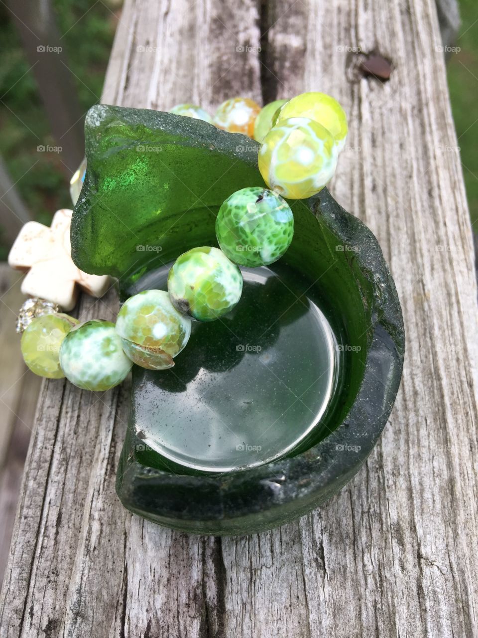 Green bracelet on glass