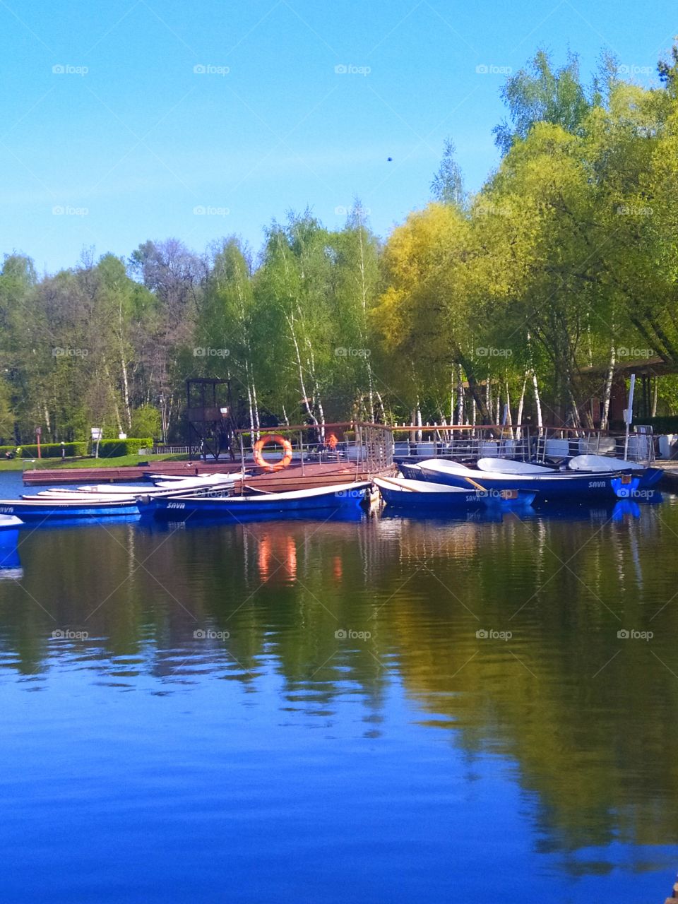 Wooden boats on the pier.Reflection in water