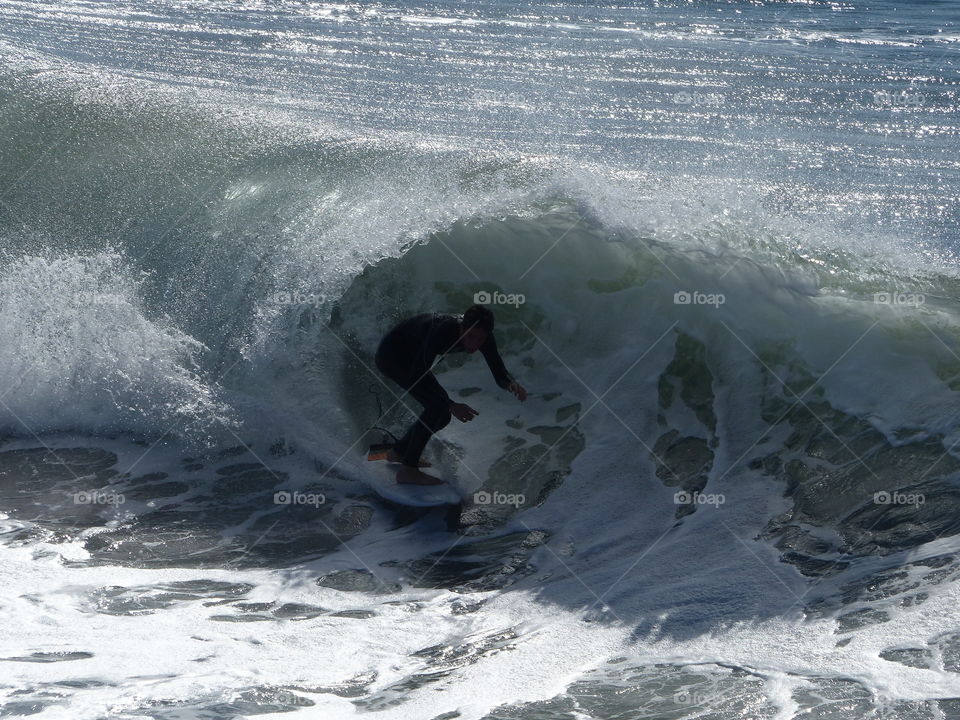 Silhouette surfer shooting curl