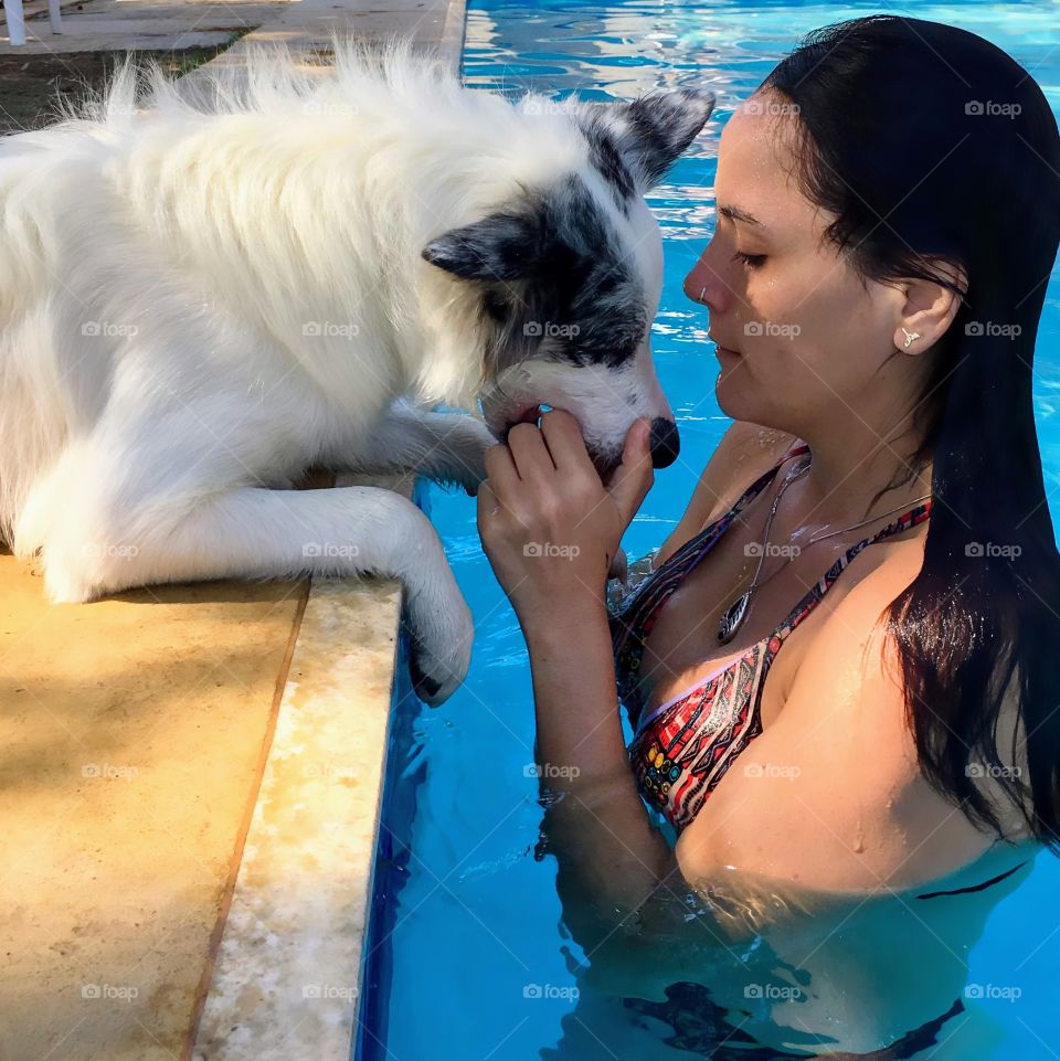 girl with her dog in the pool
