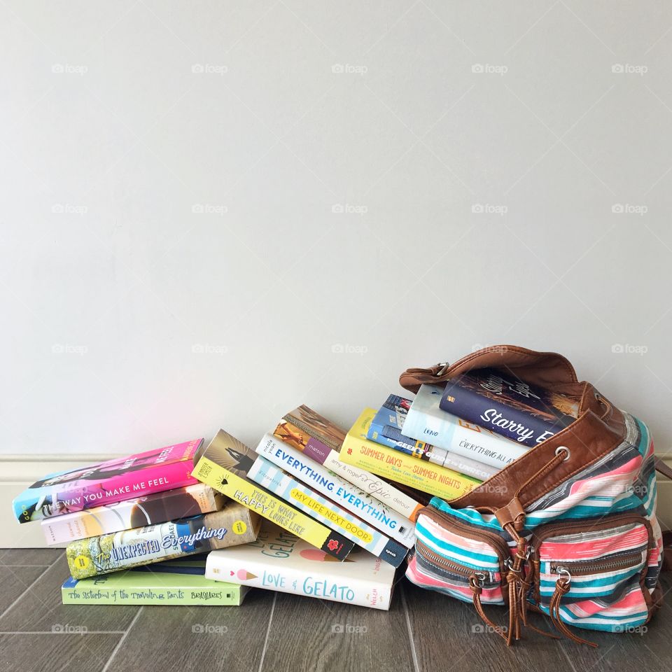 Bag with a pile of books spilling out. 