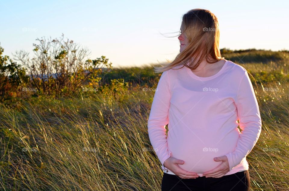 Portrait of pregnant woman in the field