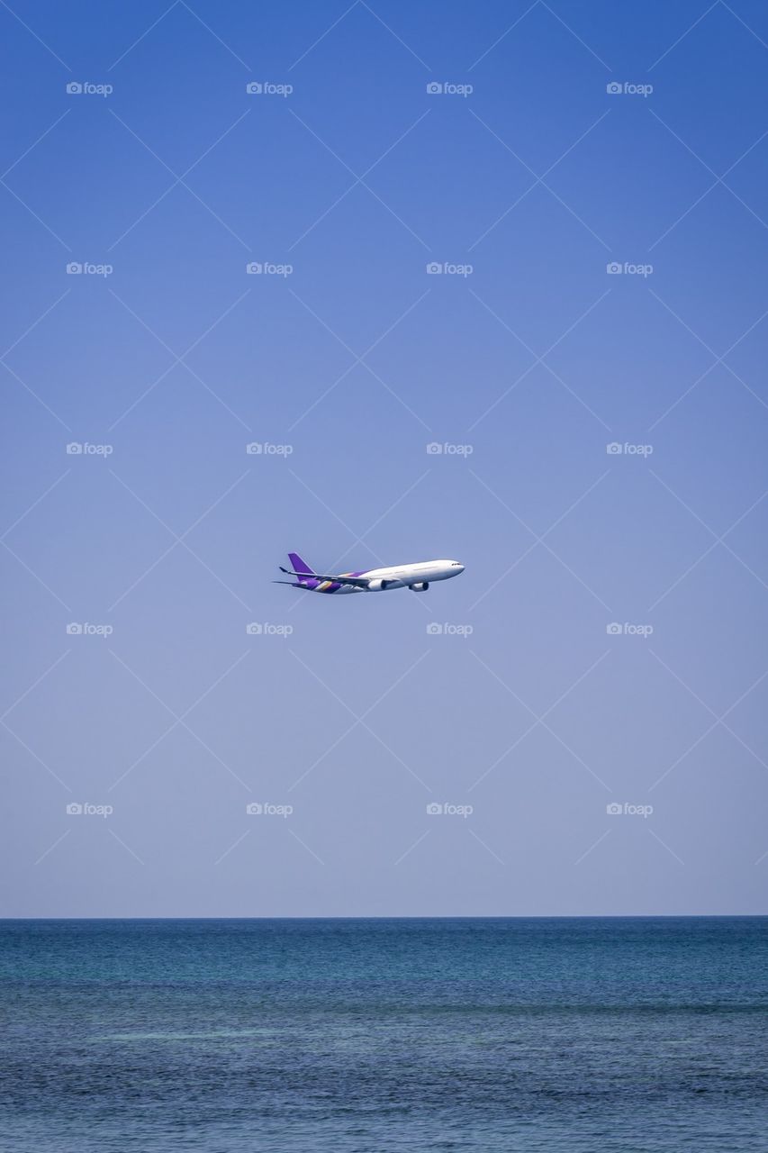 Airplane flying over sea