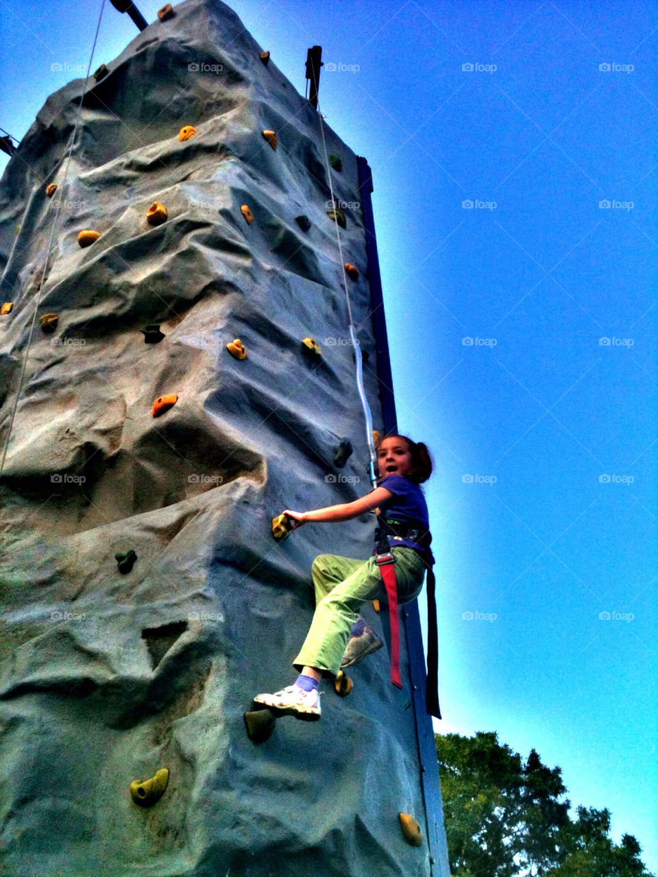 Girl Climbing a Rock Wall