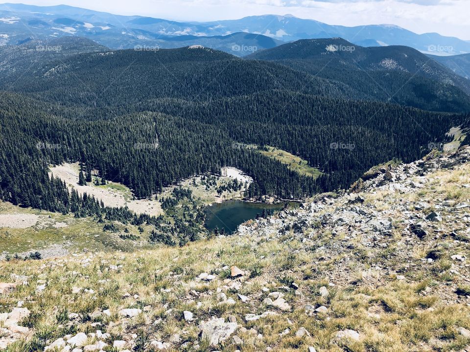 A view of A pristine alpine lake taken from a 12700’ peak.