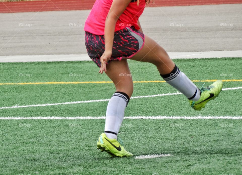 Soccer Legs. Girl Warming Up On A Soccer Pitch
