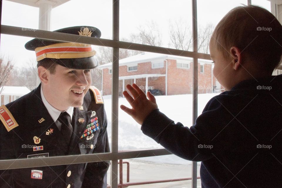 Father looks through window at son 