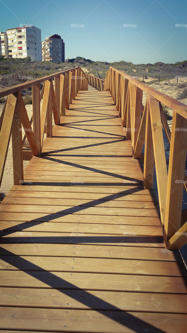 A wooden walkway from a beach