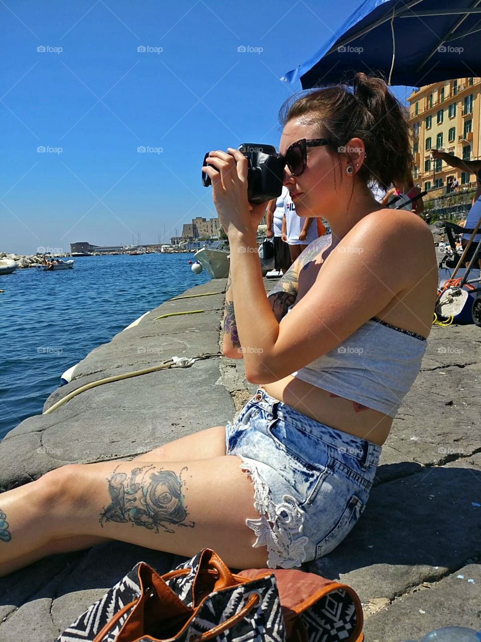 exploring Naples in Italy, capturing the scenes by the shores, taking in the sea view and feeling the sun beating down.