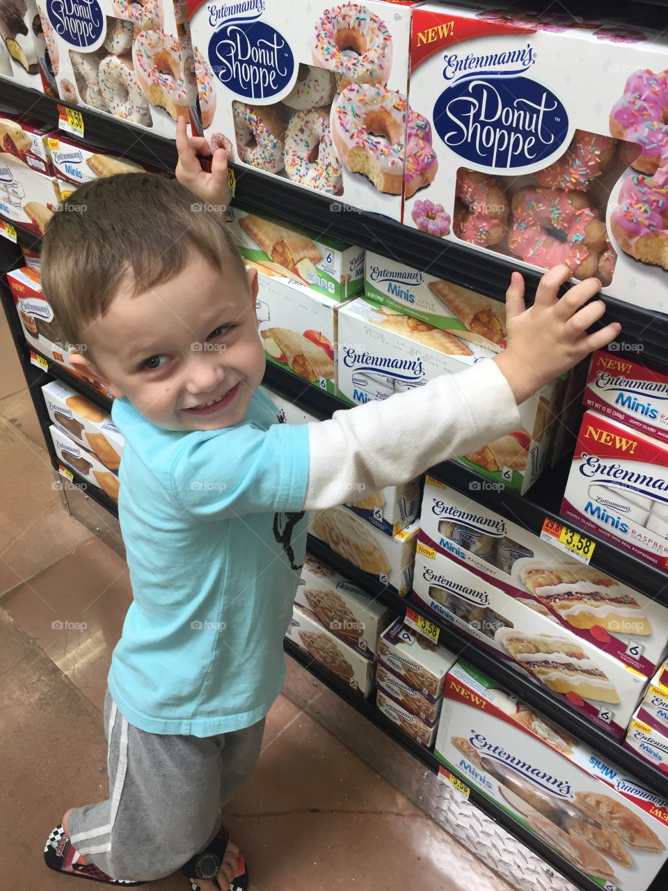 Toddler looking at donut boxes