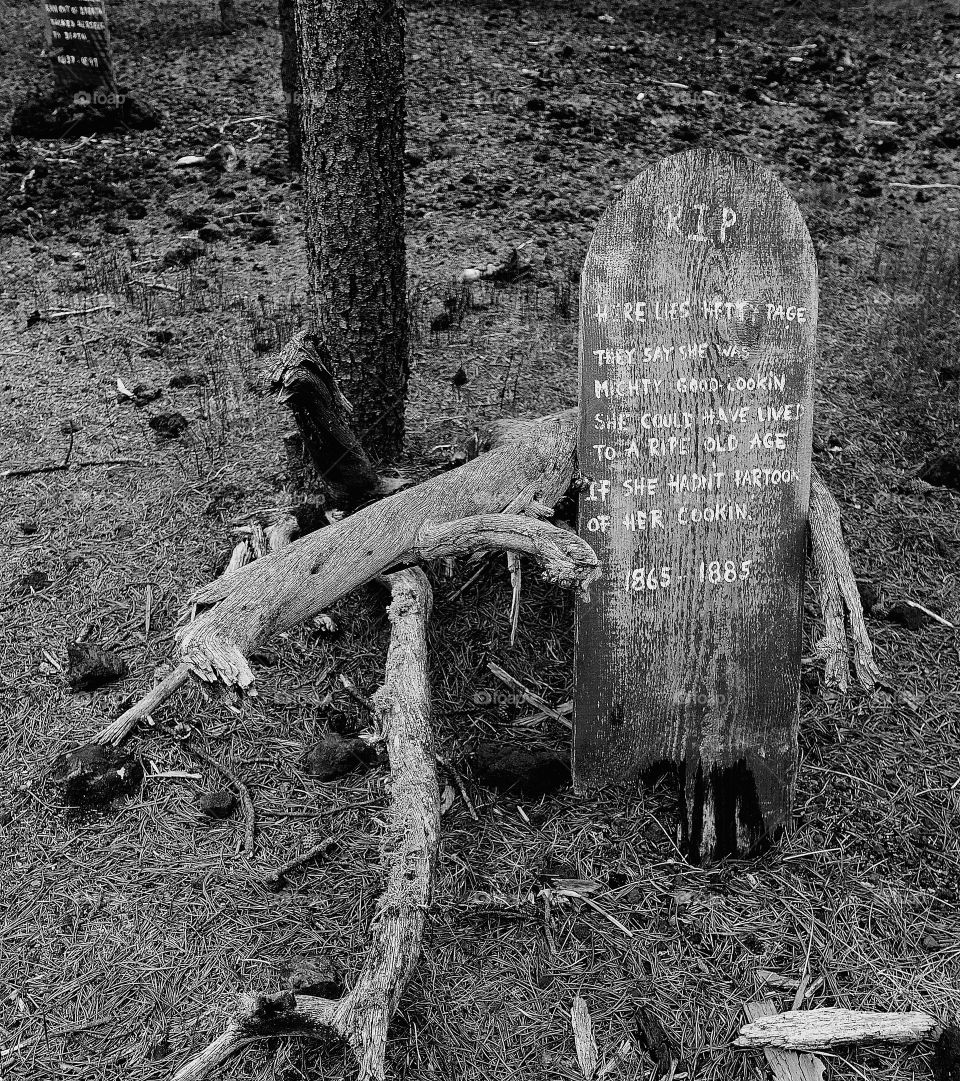 A funny wooden headstone provides a nice decoration for Halloween. 