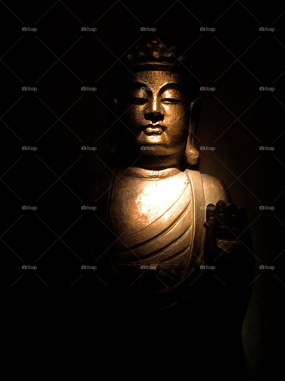 Blessings. A statue of Buddha in spotlight at a meditation hall.