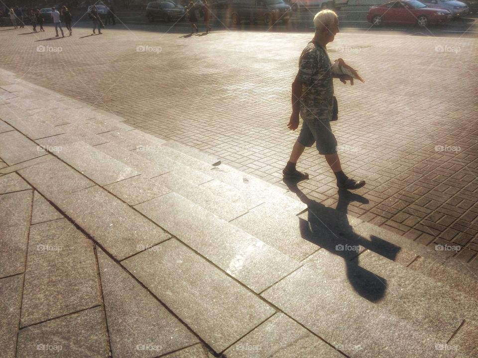 Birdman. . This picture was taken in Kiev, Ukraine at Independence Square (Maidsn). This man has a pair of doves which he suggests to tourists to ta a picture with.