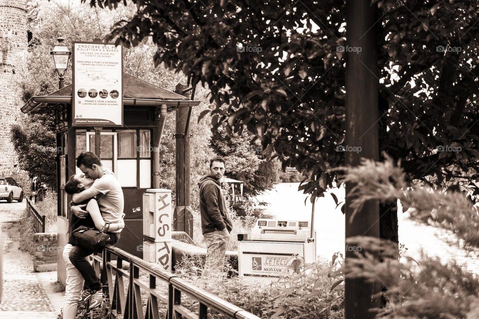 The magic of the first kiss withstands the disapproving looks of the people passing by