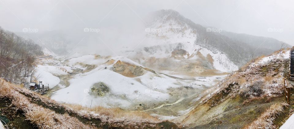 Jigokudani or Hell Valley in the town of Noboribetsu Onsen, hot steam vents, sulfurous streams and other volcanic activity, hot spring waters, Hokkaido, Japan, winter with snow