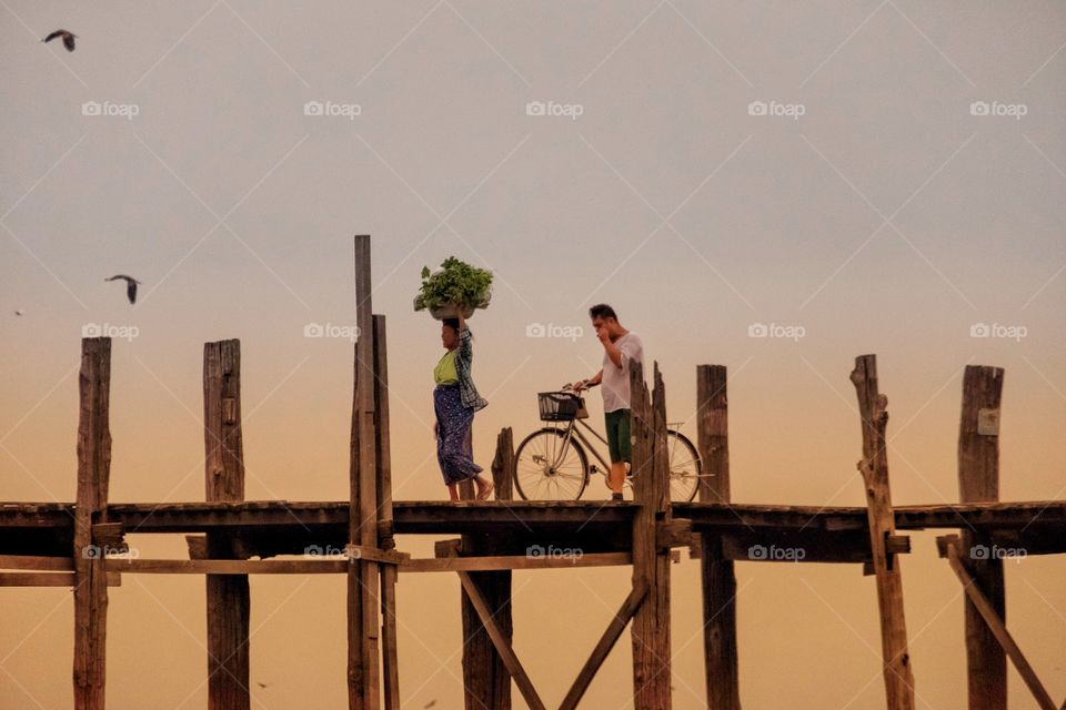 Local people are walking on U Bein the longest wooden bridge in the world to go to morning market,Mandalay Myanmar 