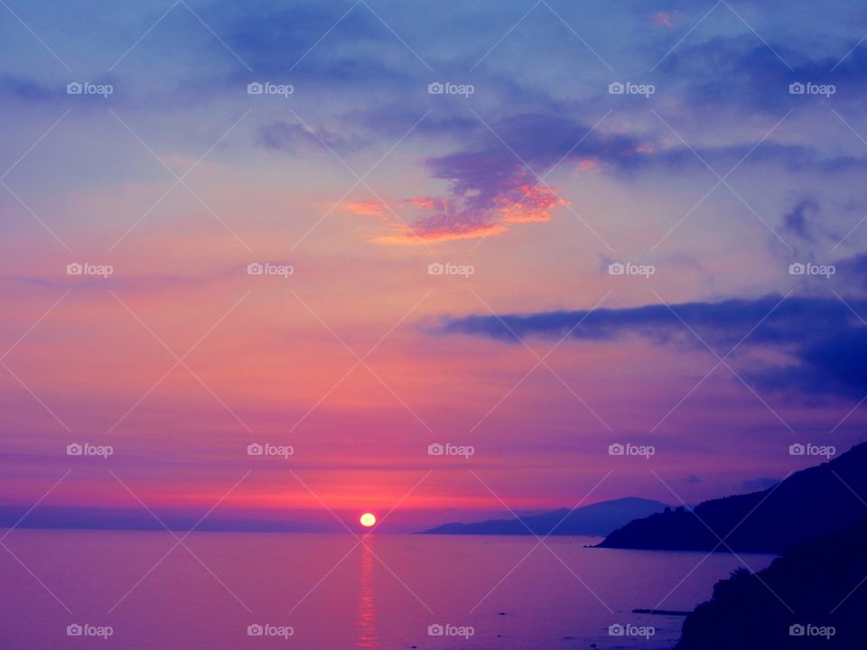 Dramatic sky over idyllic sea during sunset