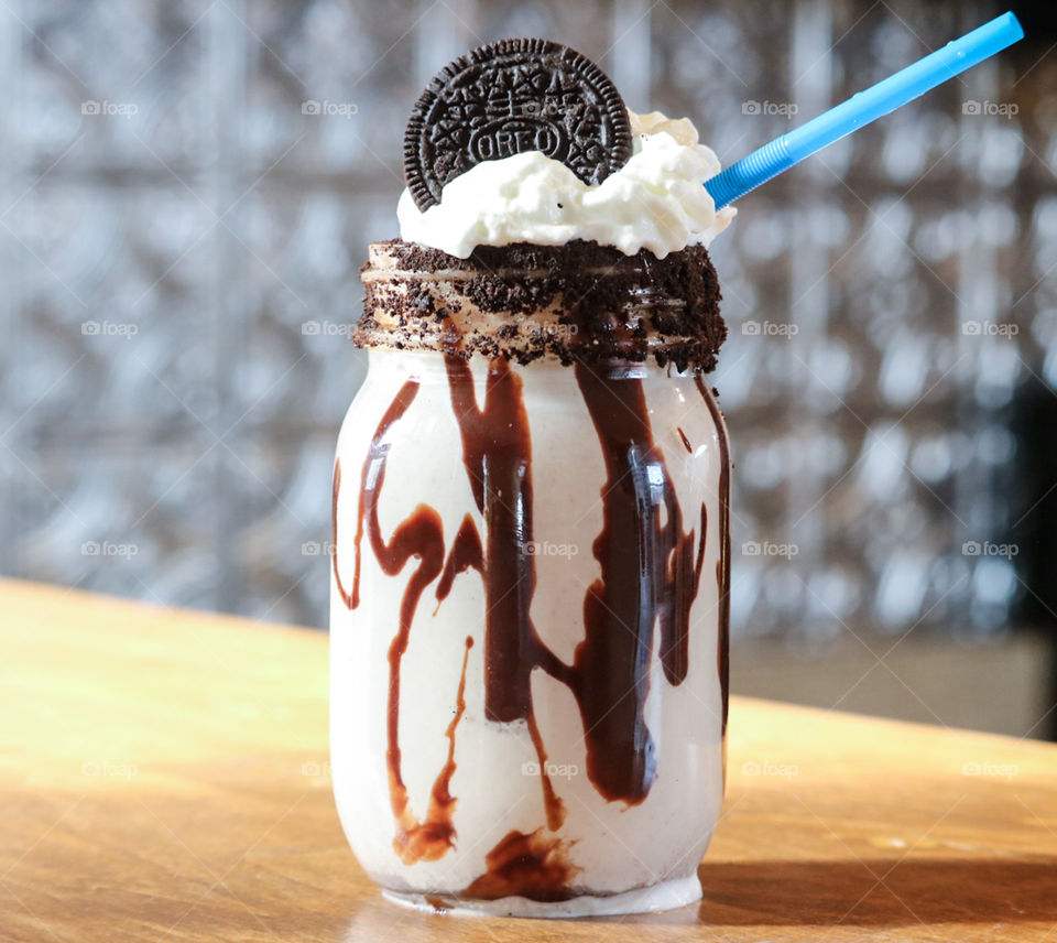 Cookies and cream Oreo Milkshake with Chocolate drizzle .