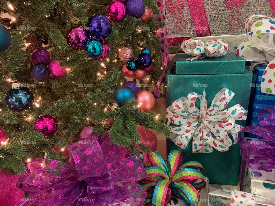 Beautiful Christmas tree and colorful wrapped gifts.